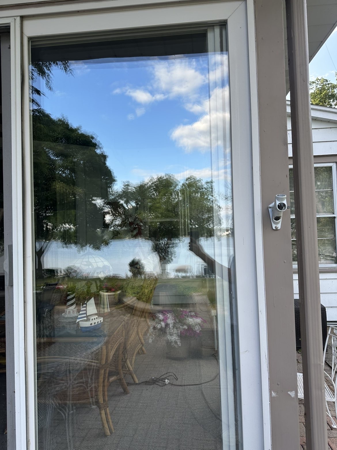 Crystal-clear residential window reflecting a bright blue Wisconsin sky